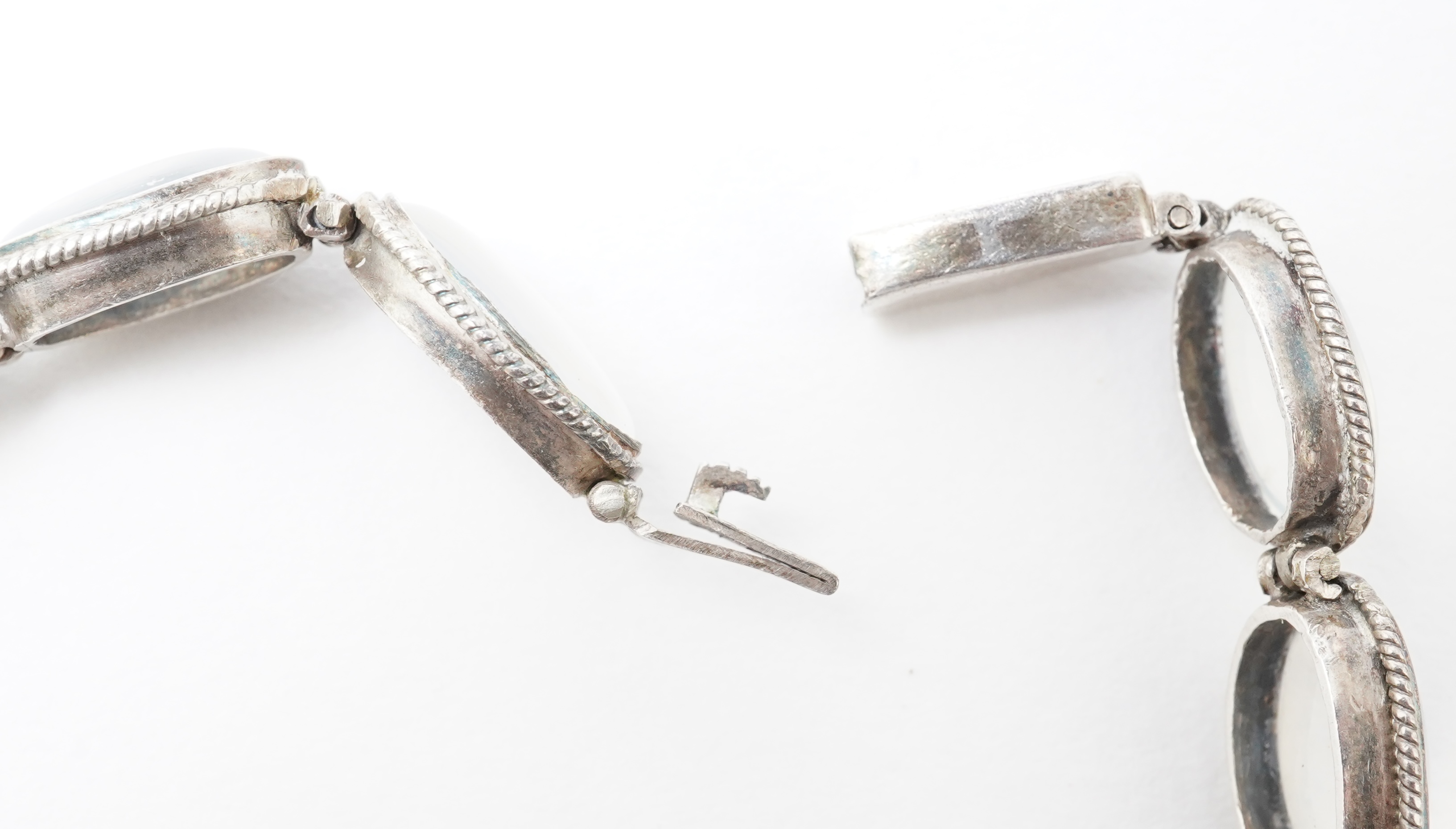 A collection of jewels and accessories including a moonstone bracelet